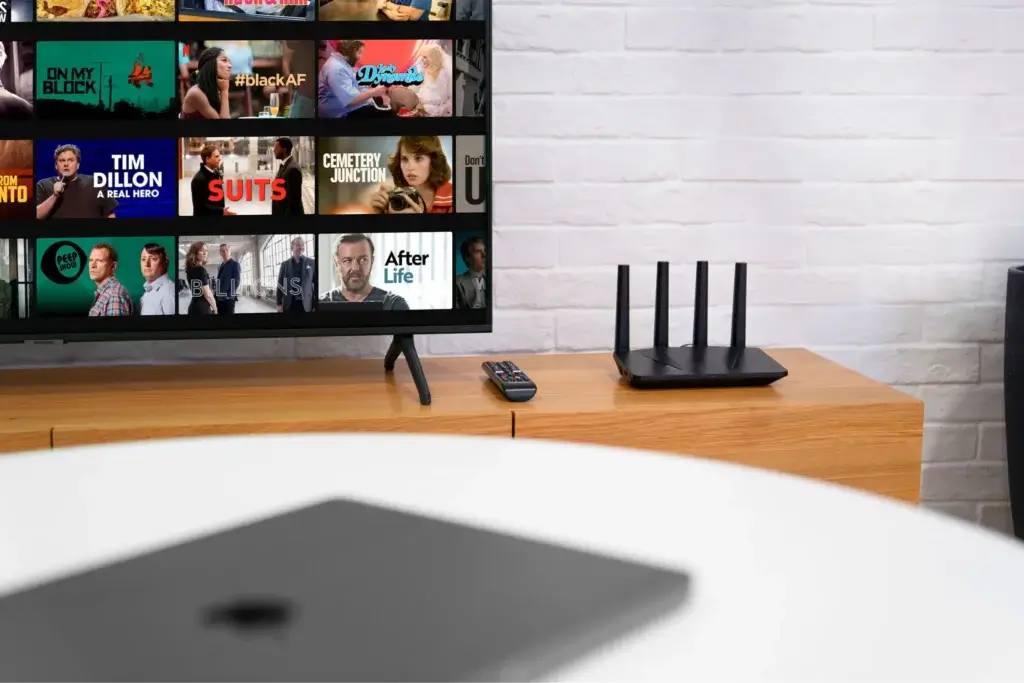 ExpressVPN router next to smart TV streaming Netflix