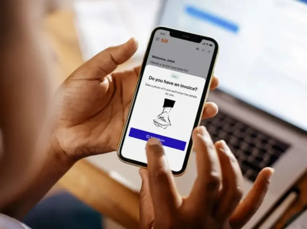 User uploading an invoice through the Bill.com mobile app for automated data capture.