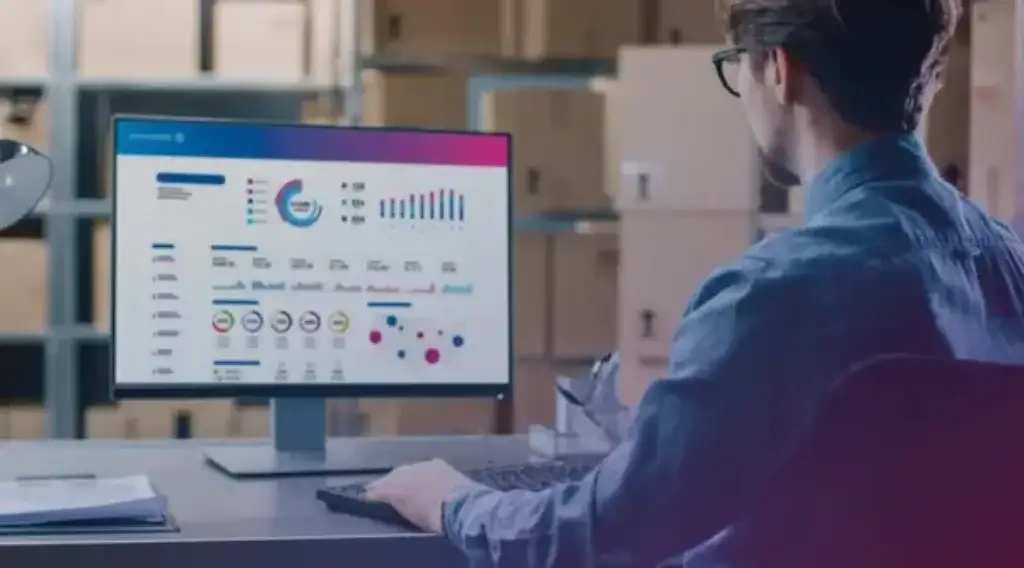 User reviewing PitneyShip analytics dashboard in a warehouse environment