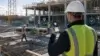 Construction supervisor using a mobile time tracking app with GPS markers and a geofence around an active jobsite